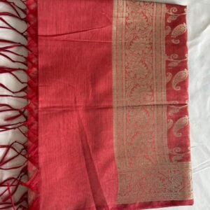 Handwoven silk saree Chanderi Dupatta is elegantly paired with a red silk saree featuring gold paisley and floral embroidery on the border, and tassels along one edge, beautifully displayed on a white surface.